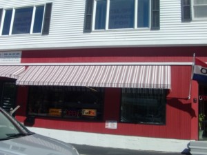 red and white commercial awning over a print business