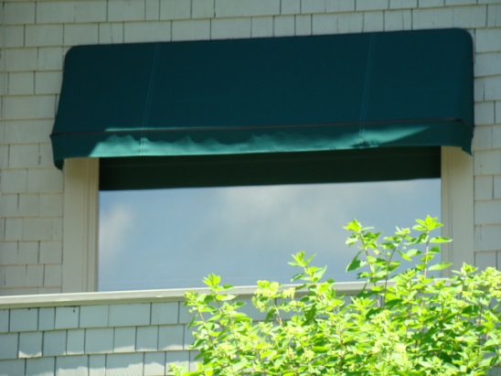 green fixed awning over a window