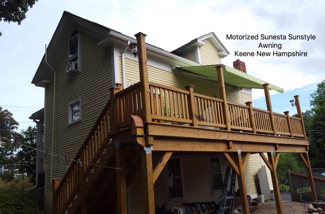 green and white striped motorized retractable awning in keene nh