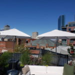 tucci umbrellas on an urban rooftop